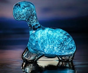 This cute little dinosaur pet glows blue at night with bioluminescent algae, and requires no batteries;  just sunlight!  