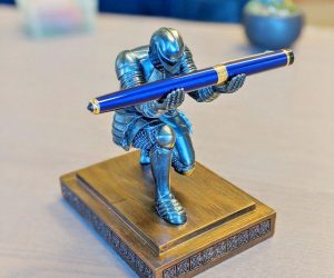 The Executive Knight Pen Holder is a bowing knight, hands raised to hold your modern quill. Your pen is held aloft, so you never have to figure out which stack